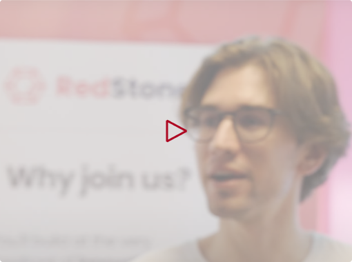 Blurred image of a man with glasses standing in front of a RedStone banner with text 'Why join us?'